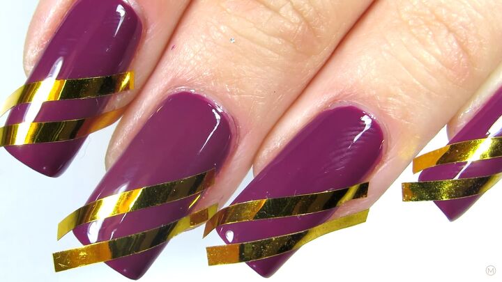 these simple gold purple christmas nails are like berries cream, Applying nail tape to the purple nails