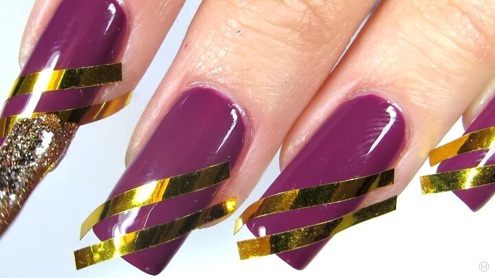 these simple gold purple christmas nails are like berries cream, Applying glittery gold nail polish to nails
