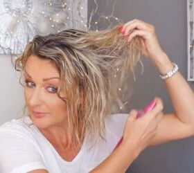 how to do a cute easy 10 minute updo on wet hair, Spraying volumizing spray onto wet hair