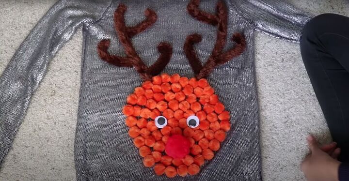 how to make your own light up christmas sweater for the festive season, Hot gluing googly eyes and a red nose