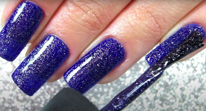 how to do fun blue snowflake nails for winter using stamping plates, Applying glitter nail polish on top