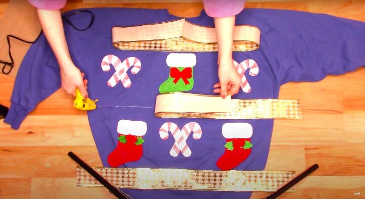 how to make a last minute diy ugly christmas sweater for the holidays, Gluing the ribbons onto the sweater