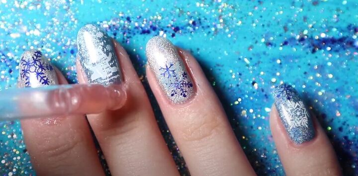 how to do easy blue silver nails with snowflakes for winter, Applying cuticle oil to nails for protection