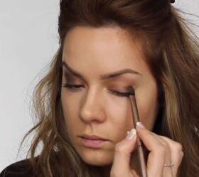 quick easy glam makeup for a new year s eve party, Applying deep eyeshadow to the outer corner