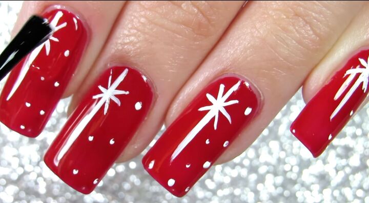how to do pretty red christmas nails with easy star snow designs, Applying a clear top coat over the designs