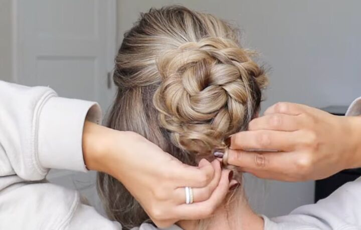 how to do a gorgeous lace french braid updo for a special occasion, Securing the lace braid to the braided bun