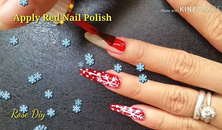ready for christmas here s how to do cute red nails with snowflakes, Applying red nail polish to the nail