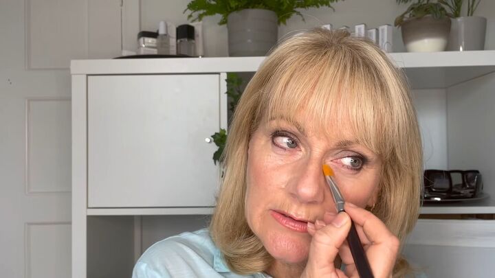 how to cover dark circles under eyes on mature skin step by step, Tapping in concealer under eyes
