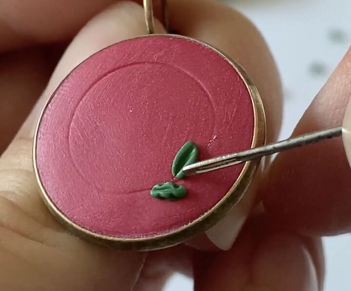 these intricate diy poinsettia earrings are made from polymer clay, Creating texture in the leaves with a needle