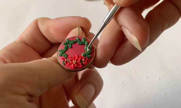 these intricate diy poinsettia earrings are made from polymer clay, Adding white details to the earrings
