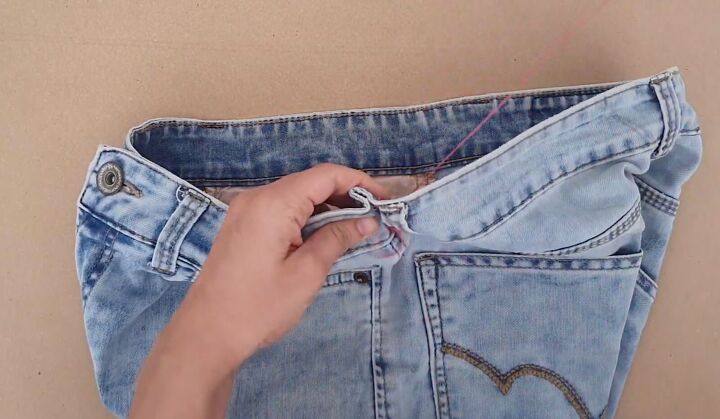 how to downsize jeans with without sewing 6 different ways, Pulling the thread to close the seam