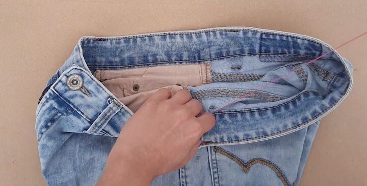 how to downsize jeans with without sewing 6 different ways, Knotting the thread inside
