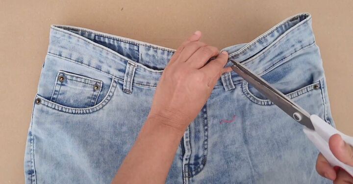 how to downsize jeans with without sewing 6 different ways, Snipping the inner layer with scissors