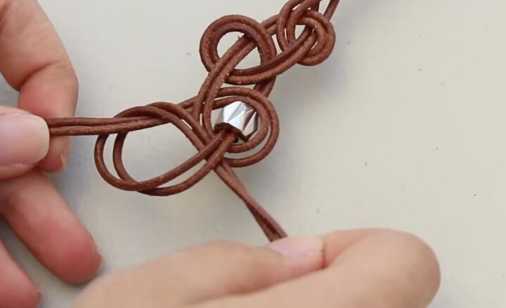 how to make a leather necklace with knots braids silver beads, Tying an empty knot after the bead