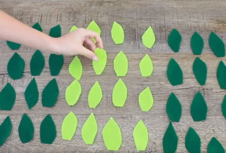 6 amazing diy ugly christmas sweater ideas including 1 for hanukkah, Cutting out leaf shapes in green felt