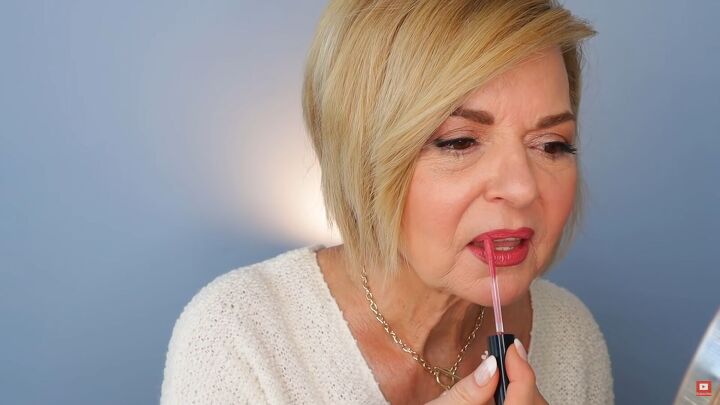 how to fake big lips over 50 lipstick tutorial for mature women, Applying lip gloss in the center of lips