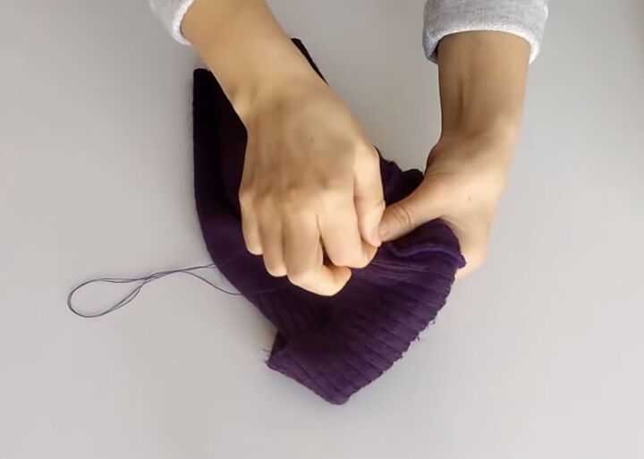 how to sew a beanie 2 ways using fleece fabric or an old sweater, Hand sewing the fold in place