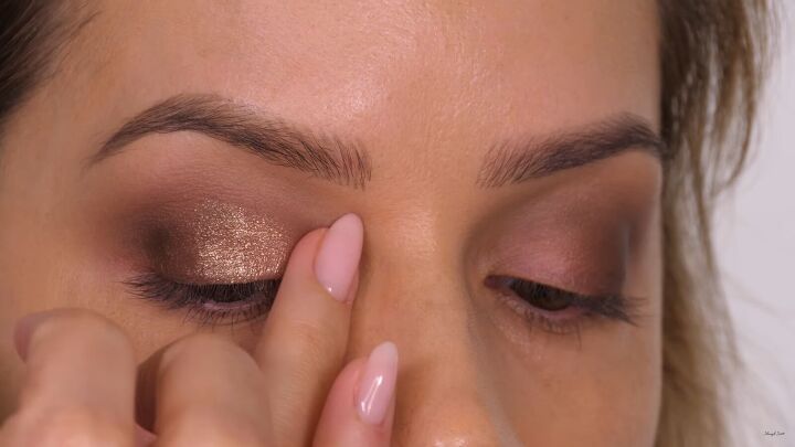 how to do a glamorous bronze makeup look with swarovski crystals, Patting a peach color onto the inner third