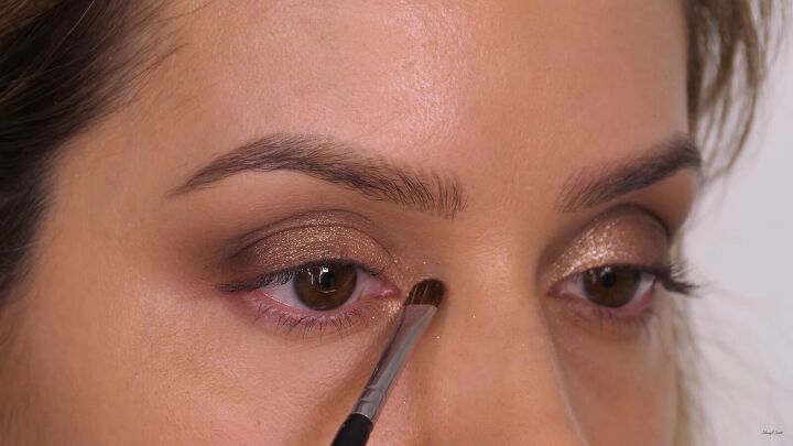 how to do a glamorous bronze makeup look with swarovski crystals, Adding a shimmer to the inner corners