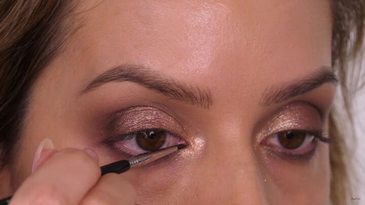 how to do a glamorous bronze makeup look with swarovski crystals, Using a gel eyeliner on the waterline