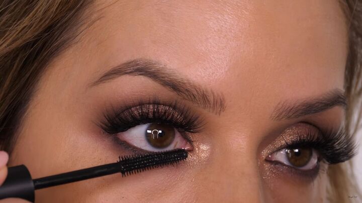 how to do a glamorous bronze makeup look with swarovski crystals, Applying a second layer of mascara