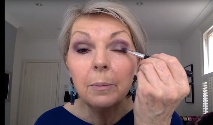 colorful eye makeup for mature eyes that s subtle flattering, Applying an eggplant colored eyeshadow
