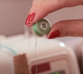 basic sewing skills how to thread a sewing machine step by step, Holding the bobbin to make the letter P