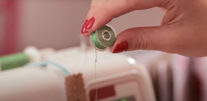 basic sewing skills how to thread a sewing machine step by step, Holding the bobbin to make the letter P