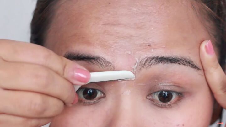 looking for painless brow grooming here s how to shave your eyebrows, Shaving eyebrows in the middle