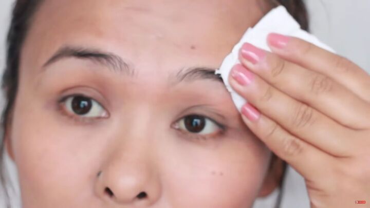 looking for painless brow grooming here s how to shave your eyebrows, Wiping off the remaining moisturizer