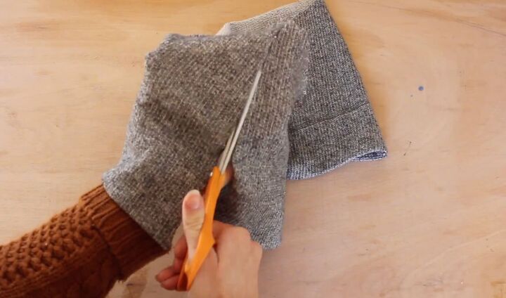 how to make a diy cropped sweater fix an unflattering fit, Cutting triangles from the extra fabric