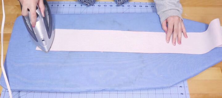 looking to upcycle old bedding try this box pleat skirt tutorial, Ironing interfacing to the waistband
