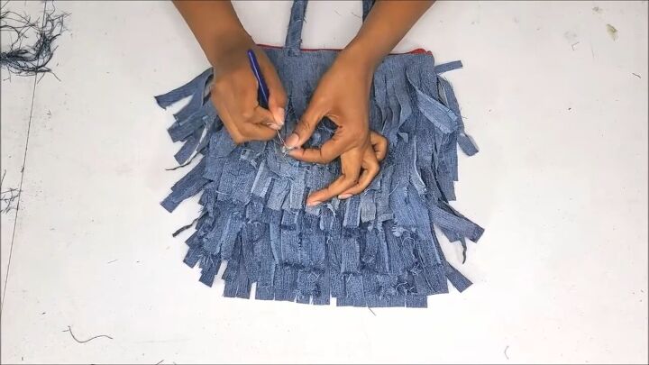 how to make a cute boho style diy fringe purse out of old jeans, Distressing the denim fringe