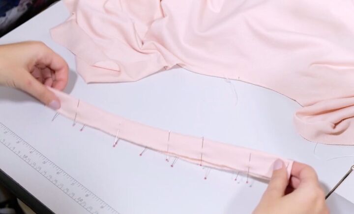 how to sew a beautiful balloon sleeve blouson sweater from scratch, Folding and pinning the neckline binding