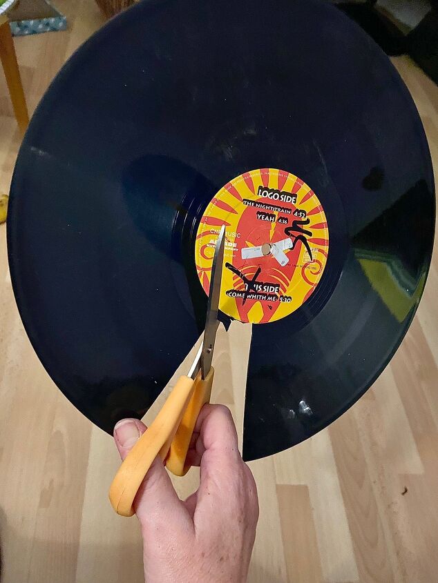 turn you old vinyl records into one of a kind earrings, Cutting a record