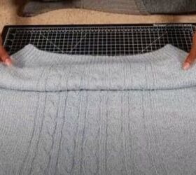 how to easily make a cute diy cropped sweater in 3 simple steps, Folding the sweater up ready to crop it