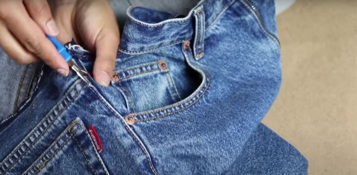 how to take in jeans the proper way for a perfect fit, Seam ripping the side seams of the jeans
