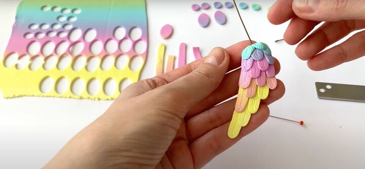 how to make polymer clay wing earrings in angelic rainbow colors, Adding top feathers to the earring