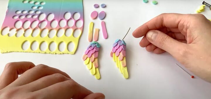 how to make polymer clay wing earrings in angelic rainbow colors, Adding a final layer of feathers