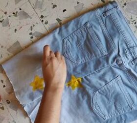 how to make cut off jean shorts skirts super easy tutorial, Painting yellow stars on the DIY denim skirt
