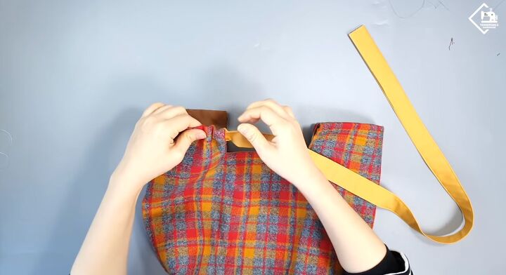 how to sew a cute plaid purse perfect for fall and winter, Inserting the straps into the casing