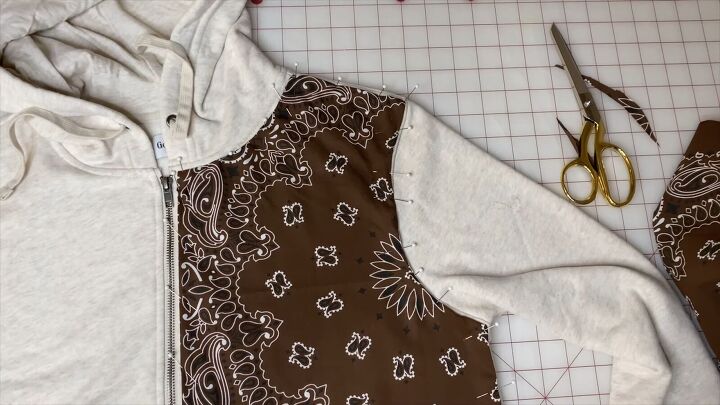 how to make a cute bandana patchwork hoodie in a few simple steps, Pinning the bandana fabric to the hoodie