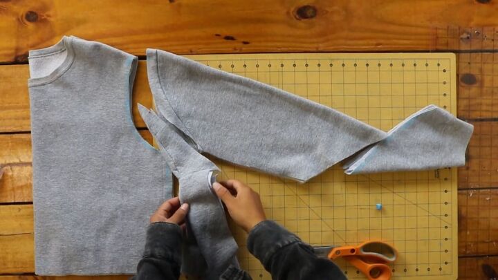 2 easy diy sweatshirt refashions making bandana flannel sleeves, Cutting away the excess fabric