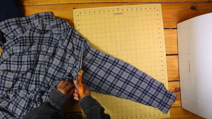 2 easy diy sweatshirt refashions making bandana flannel sleeves, Cutting off the sleeves of the flannel shirt