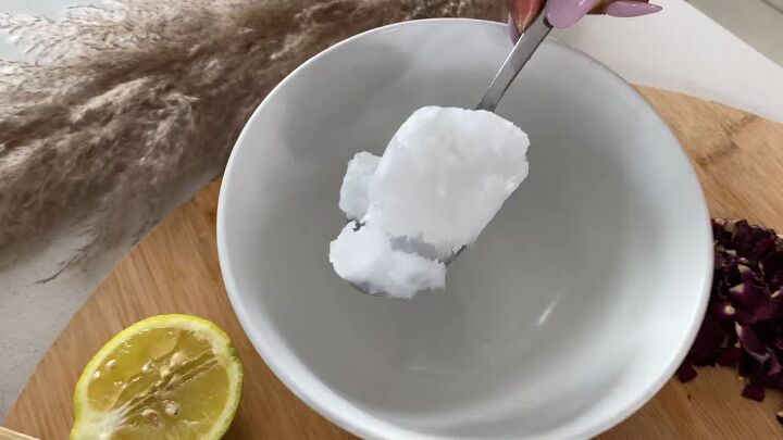 how to make a rejuvenating coconut oil epsom salt body scrub, Scooping coconut oil into a mixing bowl
