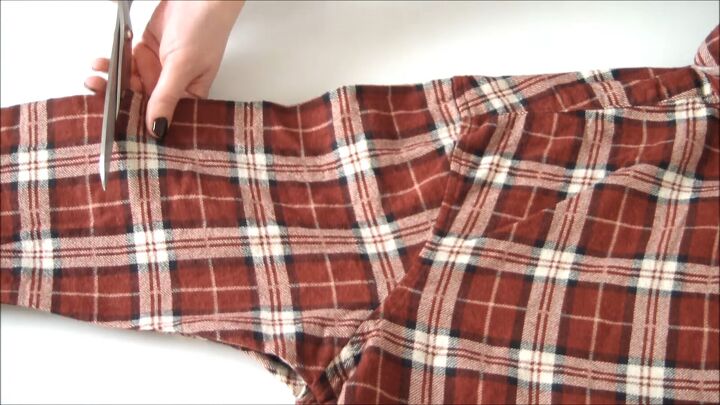 how to make a cozy flannel shirt dress out of 2 old shirts, Cutting off the sleeves of the DIY flannel dress