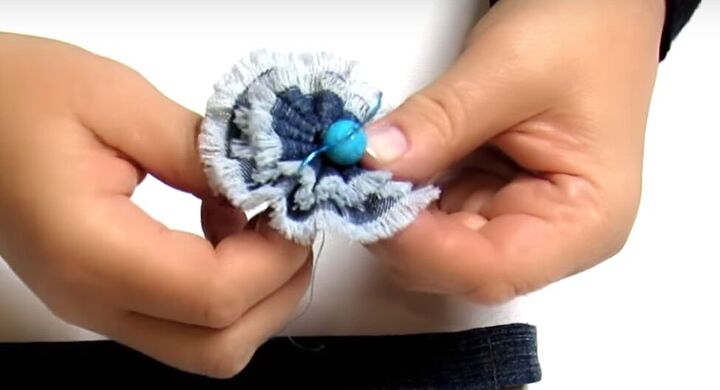 how to make cute diy denim bracelets cuffs out of old jeans, Attaching the flowers to the DIY denim cuff