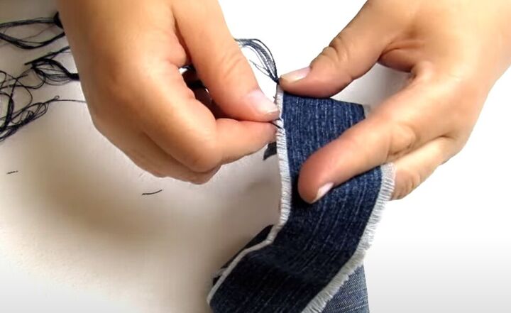 how to make cute diy denim bracelets cuffs out of old jeans, Fraying the edges of the DIY denim cuff
