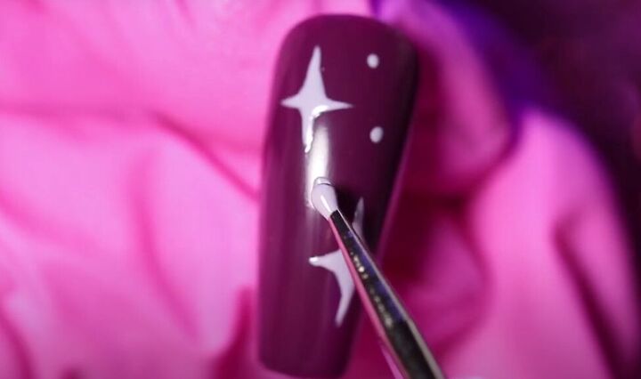 how to do adorable red purple and pink valentine s day nails, Painting lilac stars on a deep purple nail