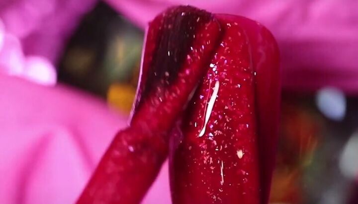 how to do adorable red purple and pink valentine s day nails, Painting a nail with glittery red nail polish